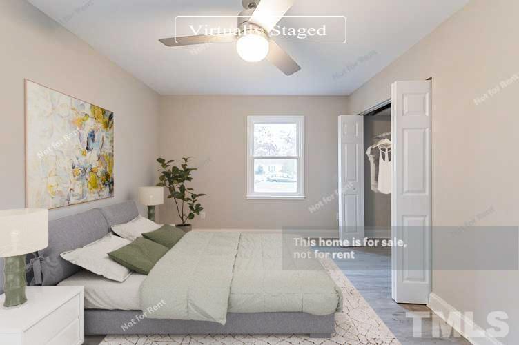 1328 Clermont Road Durham, NC 27713 - Photo 3 of 25 a bedroom with a large bed and a chandelier