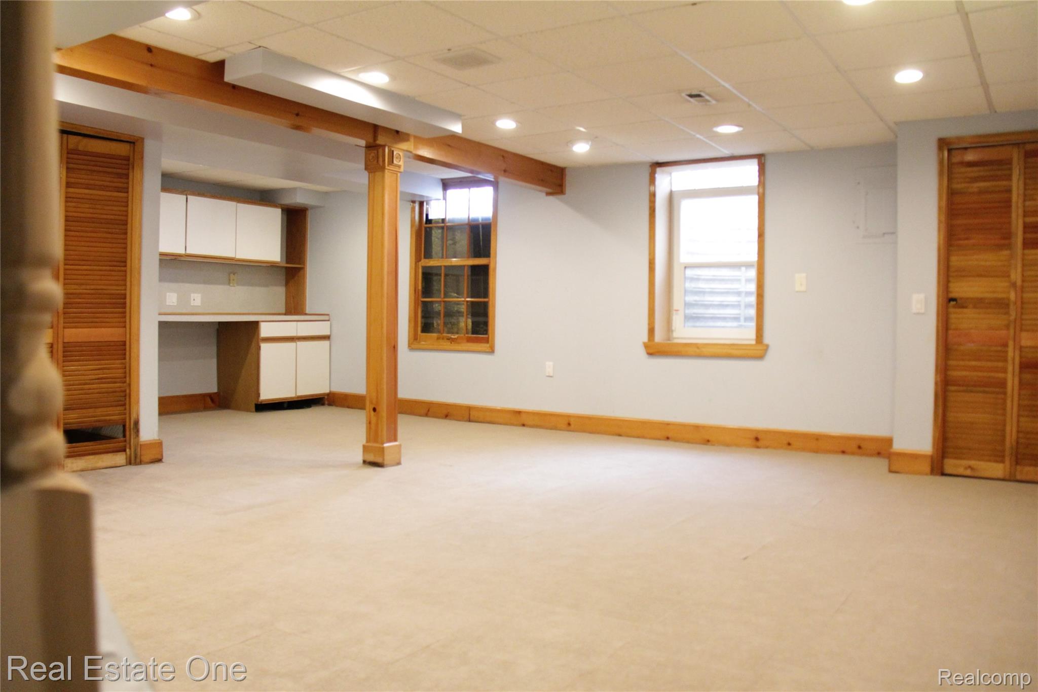44777 Saltz Road Canton, MI 48187 - Photo 58 of 65 Spacious finished room featuring neutral carpeting, recessed lighting, two windows with wood trim, and built-in cabinetry with a desk area