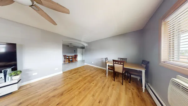 a dining room with furniture and wooden floor