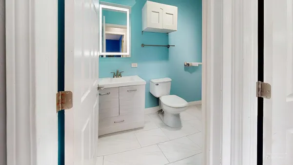 a bathroom with a toilet and a sink