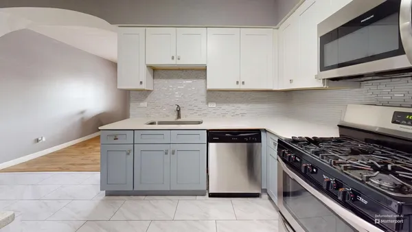a kitchen with cabinets and appliances