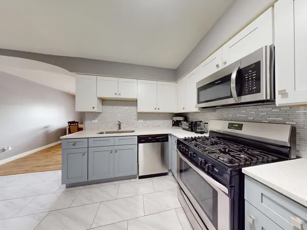 a kitchen with cabinets appliances and a window
