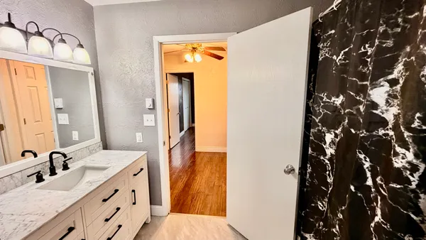 a bathroom with a double vanity sink and mirror