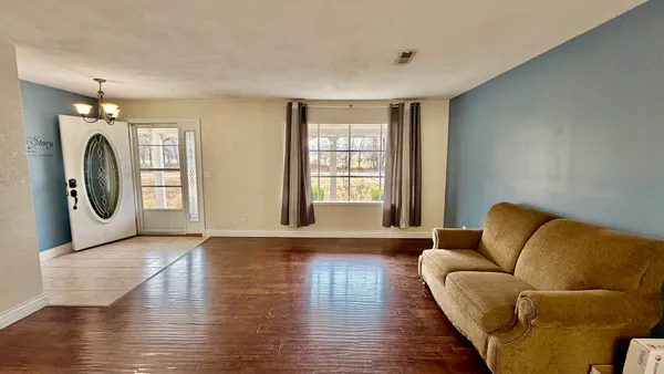a living room with furniture and a large window