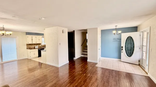 a view of a kitchen with a refrigerator a stove top oven a washer and dryer
