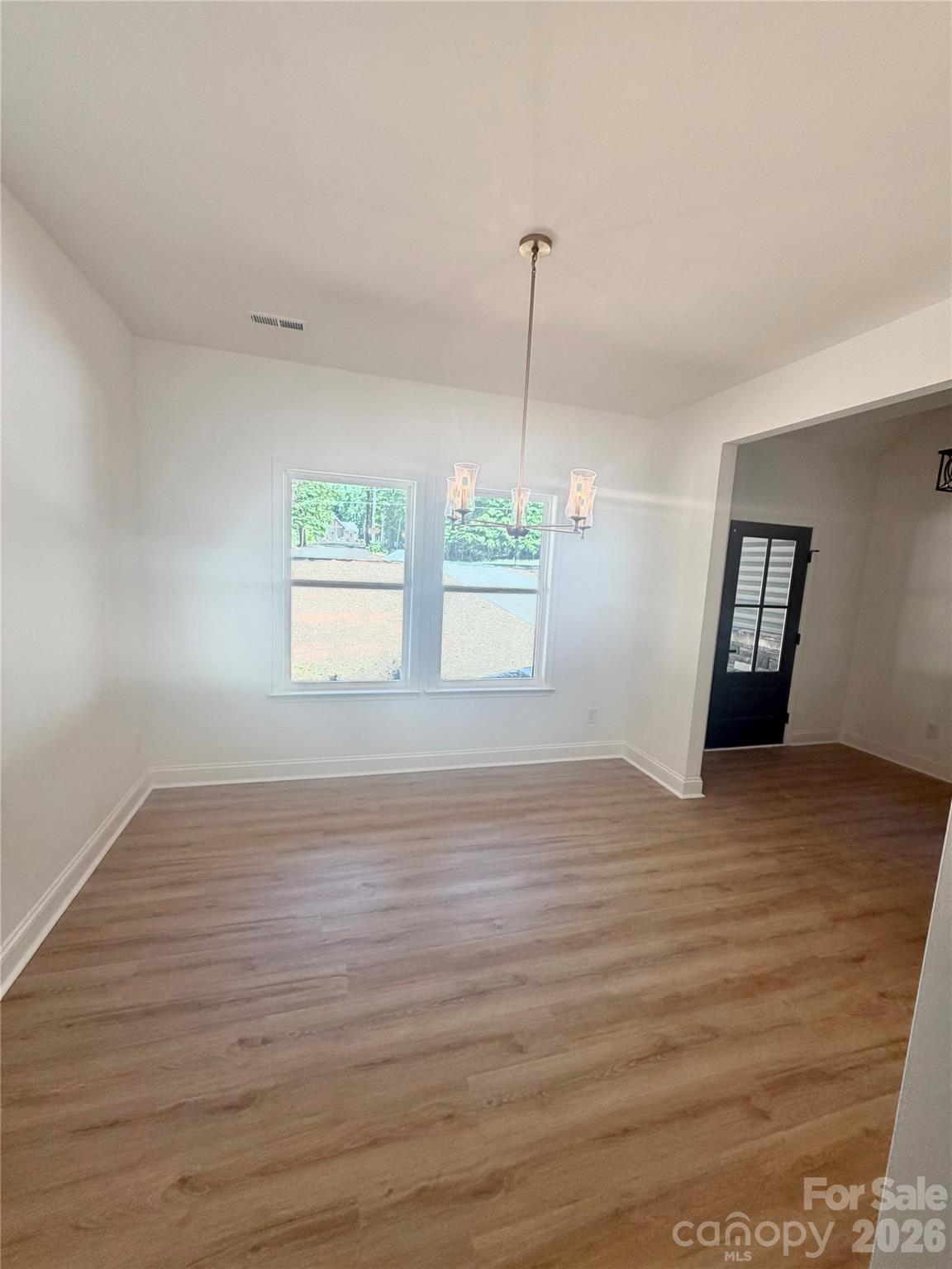 320 Blue Heron Road Salisbury, NC 28146 - Photo 11 of 22 a view of an empty room with window and wooden floor