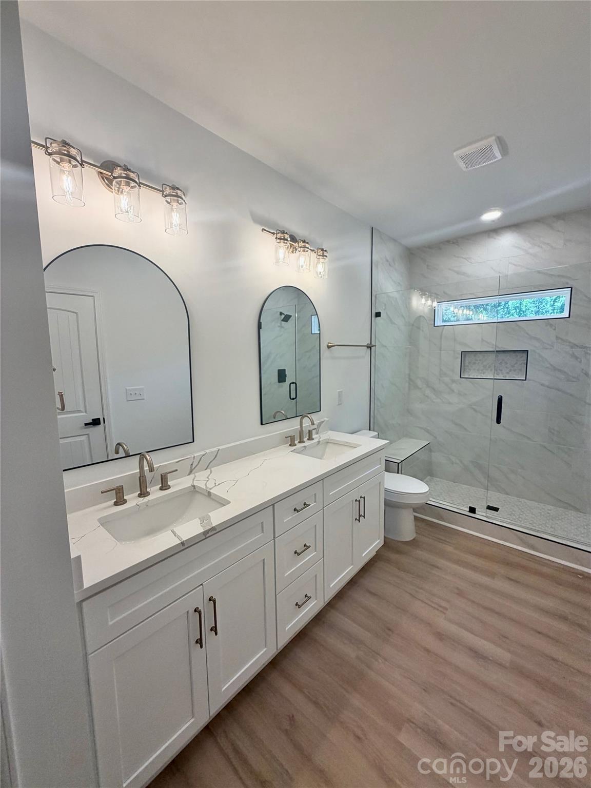320 Blue Heron Road Salisbury, NC 28146 - Photo 12 of 22 a spacious bathroom with a double vanity sink a large mirror and a bathtub