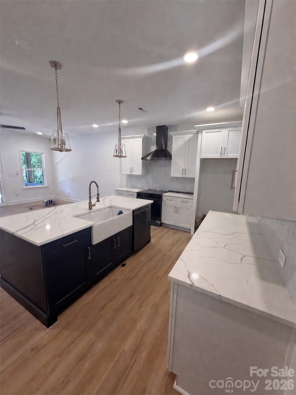 320 Blue Heron Road Salisbury, NC 28146 - Photo 6 of 22 a large white kitchen with sink and white cabinets