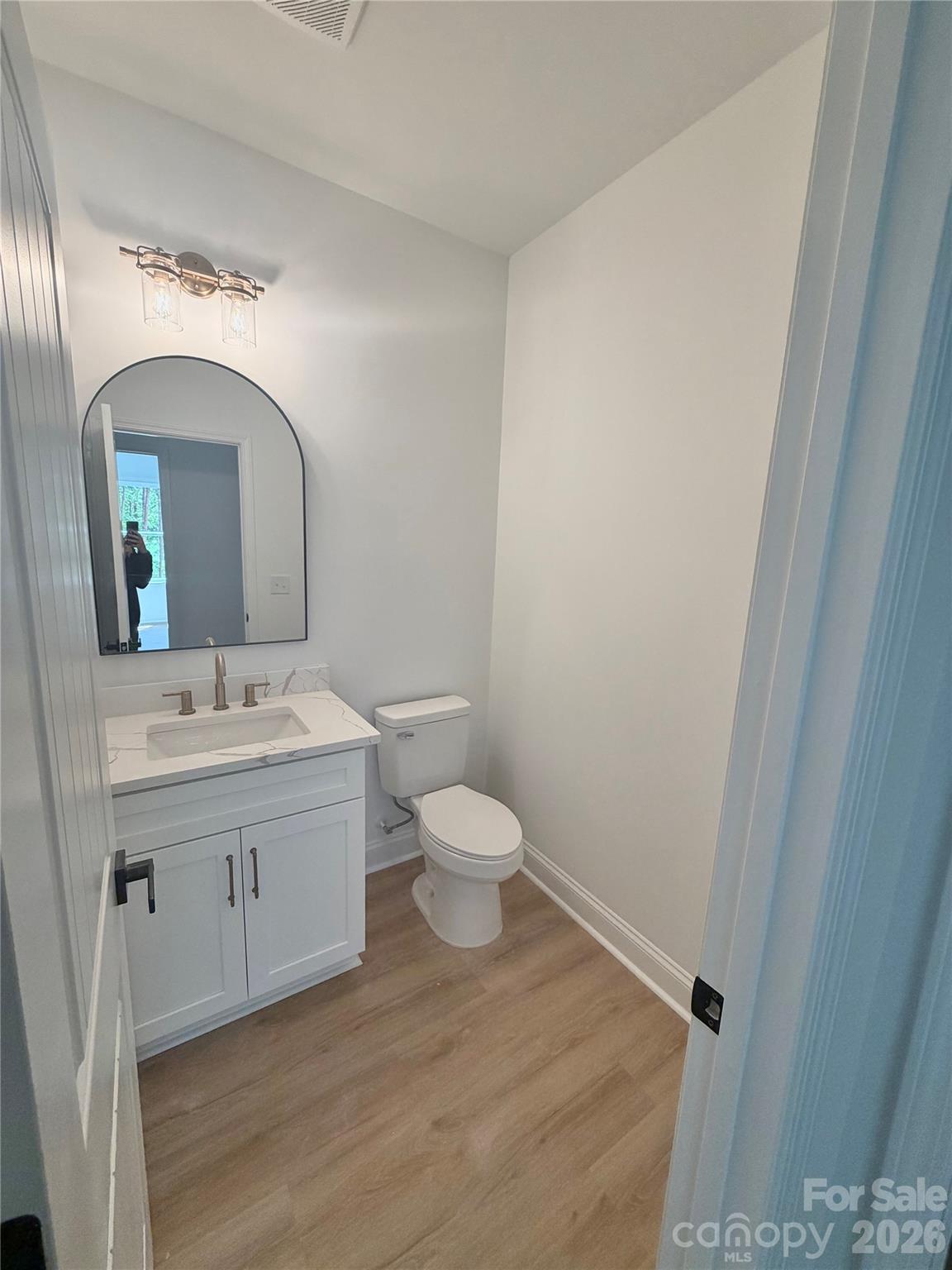 320 Blue Heron Road Salisbury, NC 28146 - Photo 7 of 22 a bathroom with a toilet sink and mirror