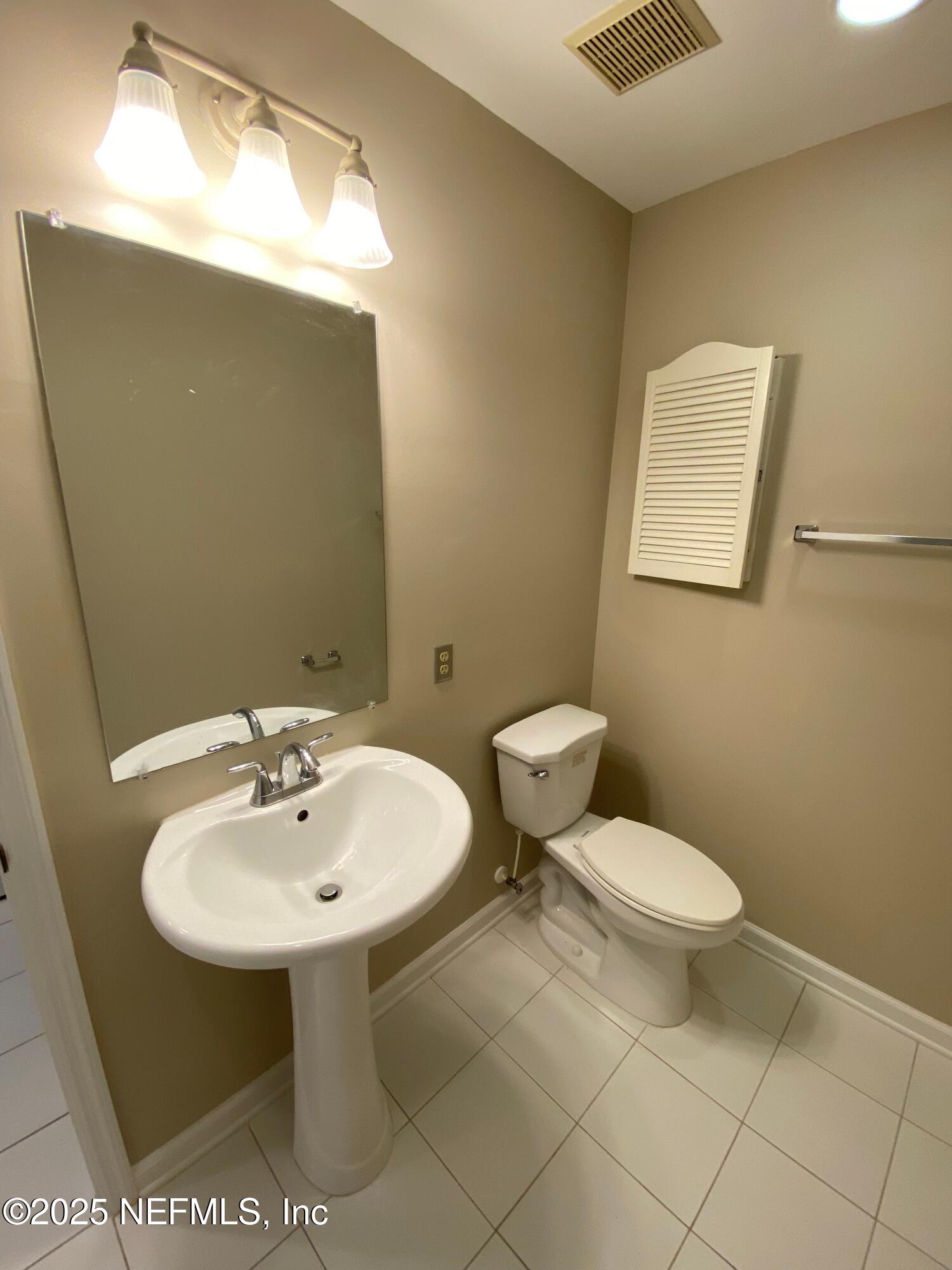 4129 Quiet Creek Loop Middleburg, FL 32068 - Photo 20 of 24 a bathroom with a sink a toilet and mirror