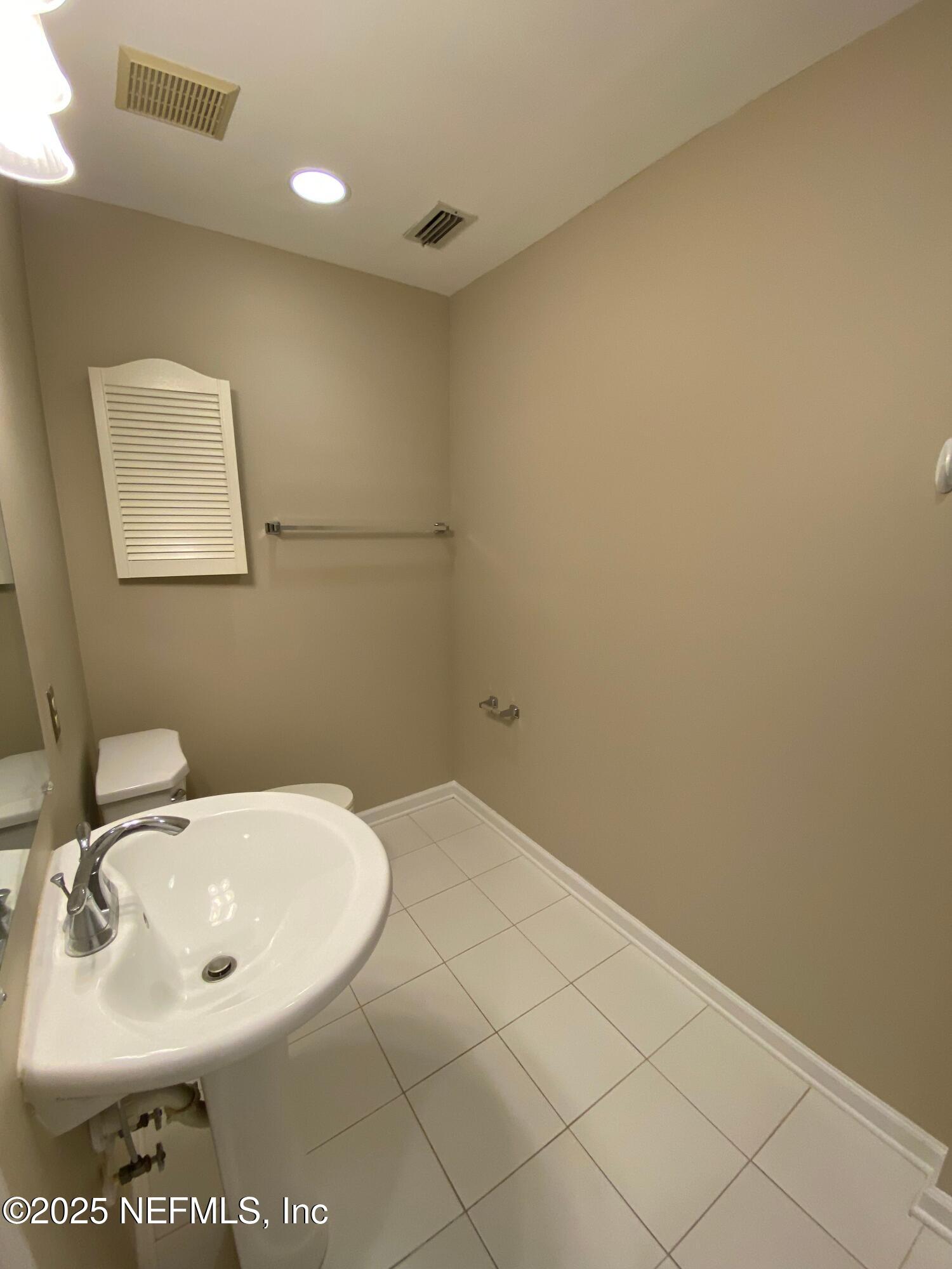 4129 Quiet Creek Loop Middleburg, FL 32068 - Photo 21 of 24 a bathroom with a sink and a mirror