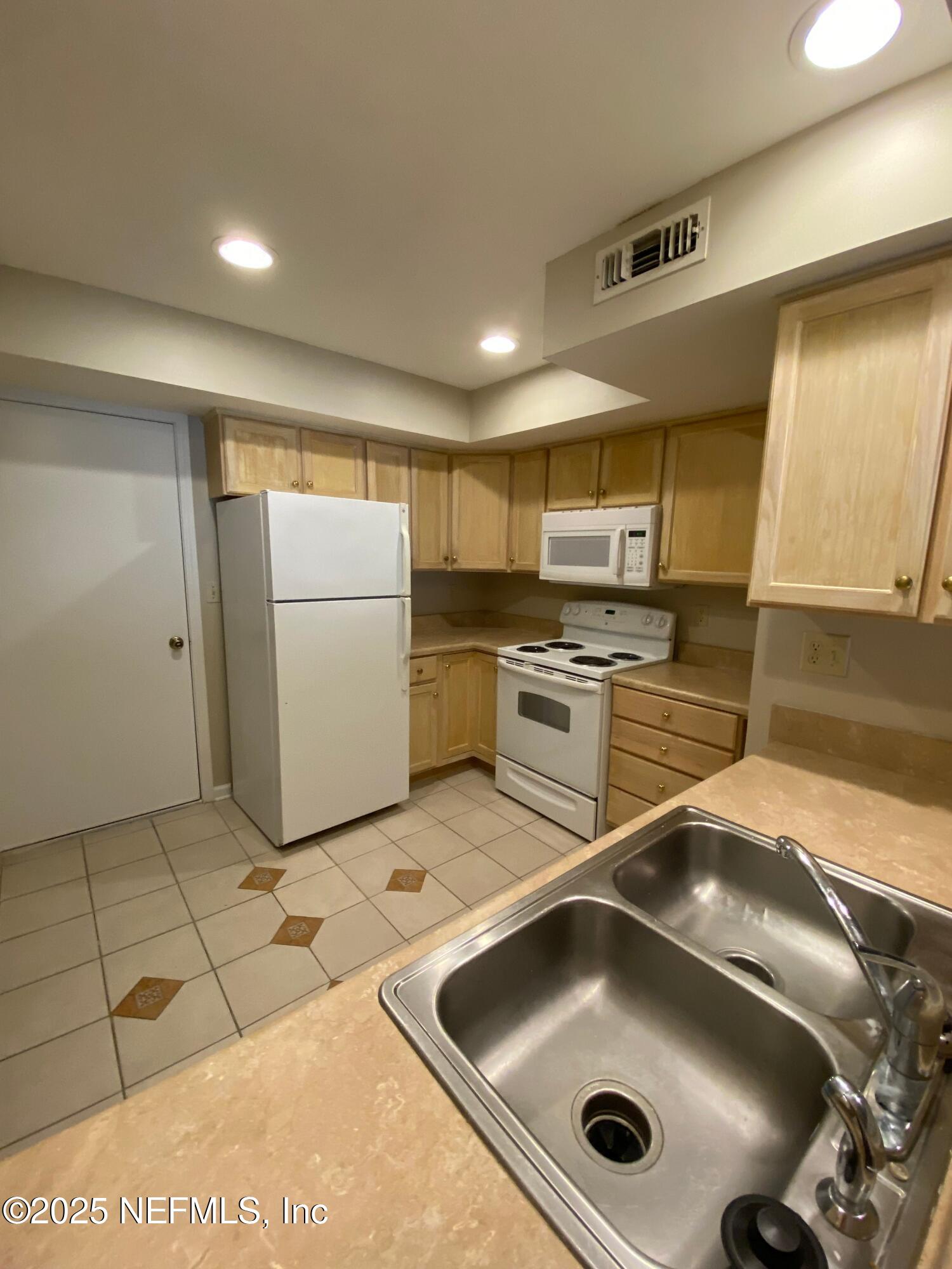 4129 Quiet Creek Loop Middleburg, FL 32068 - Photo 6 of 24 a kitchen with a sink appliances and cabinets