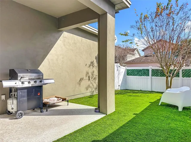 a living room with furniture kitchen view and a wooden floor