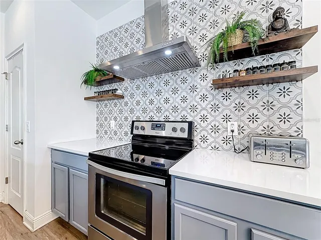 a view of a dining room with furniture wooden floor and a chandelier