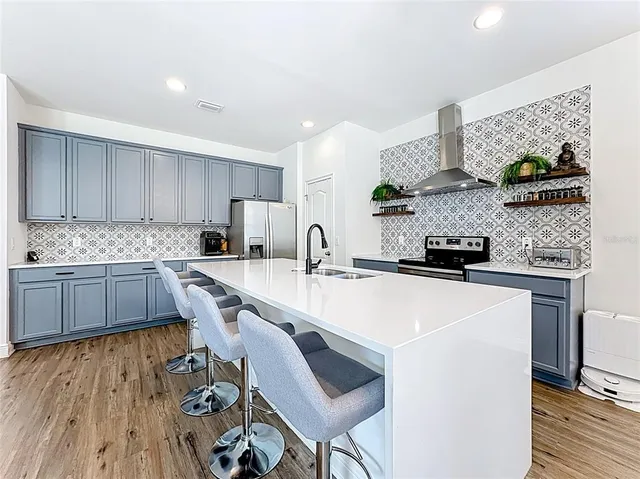 a kitchen with granite countertop a sink stove and cabinets
