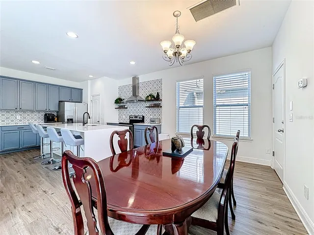 a view of a workspace with wooden floor and a window