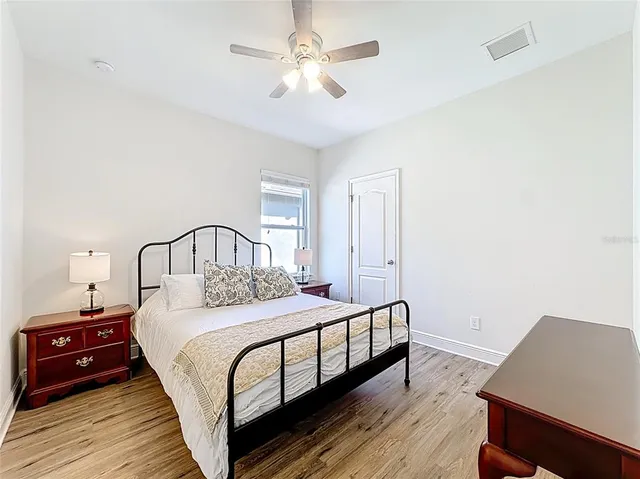 a view of a house with a yard and potted plants