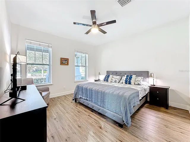 a bedroom with a bed and a desk