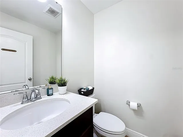 a bathroom with a sink a toilet and mirror