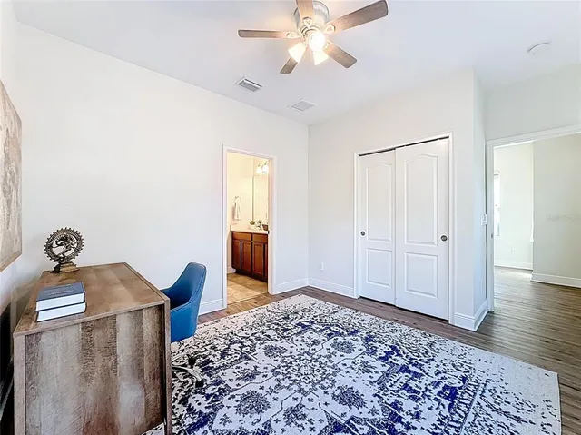 a view of a workspace with furniture and wooden floor
