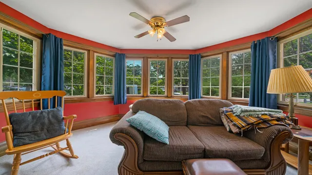 a bedroom with furniture and a large window