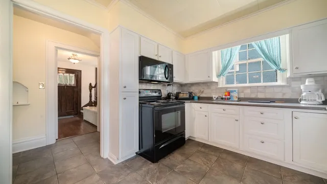 a kitchen that has a lot of cabinets in it and appliances