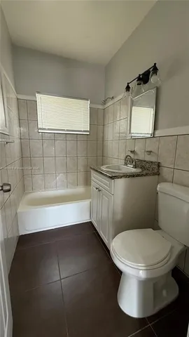 a bathroom with a toilet a sink and bathtub