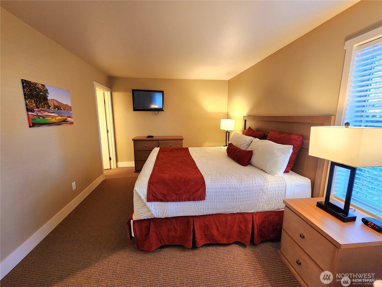 1 Lakeside 708-l Manson, WA 98831 - Photo 10 of 36 a bedroom with a bed and lamp