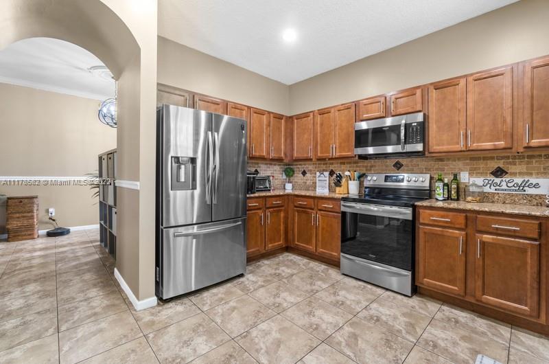 Unincorporated West Palm Beach West Palm Beach, FL 33411 - Photo 15 of 26 a kitchen with stainless steel appliances granite countertop a refrigerator sink and stove