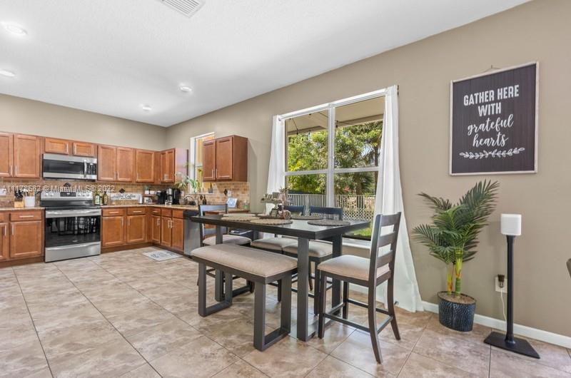 Unincorporated West Palm Beach West Palm Beach, FL 33411 - Photo 18 of 26 a kitchen with a table chairs microwave and cabinets