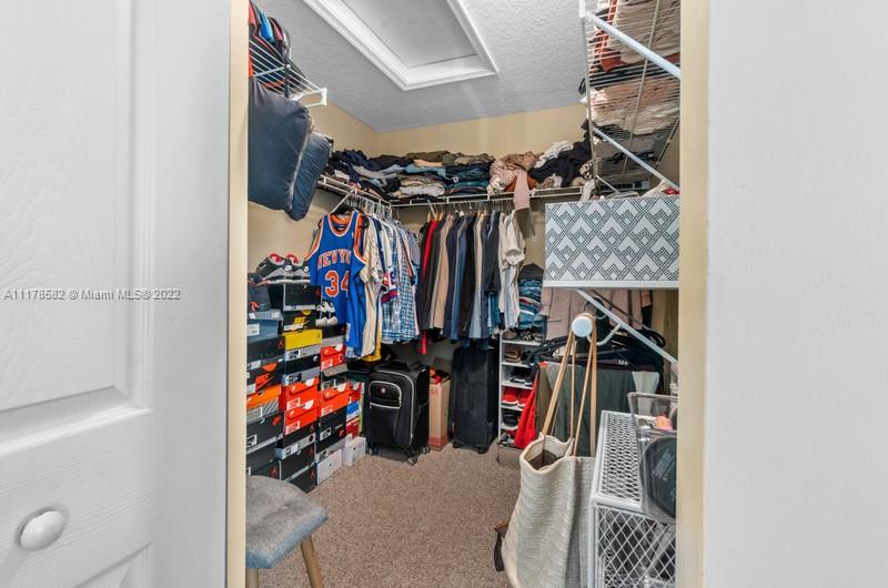 Unincorporated West Palm Beach West Palm Beach, FL 33411 - Photo 23 of 26 a view of walk in closet with clothes