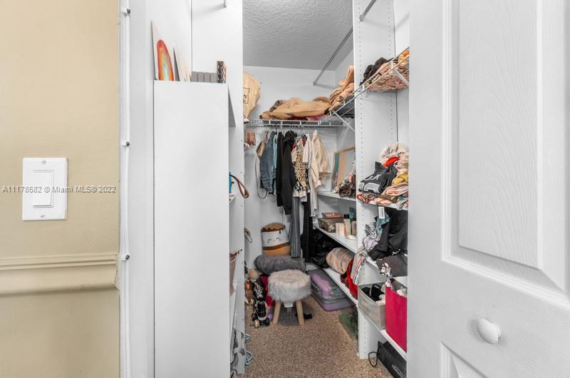 Unincorporated West Palm Beach West Palm Beach, FL 33411 - Photo 24 of 26 a view of walk in closet with clothes and shoes