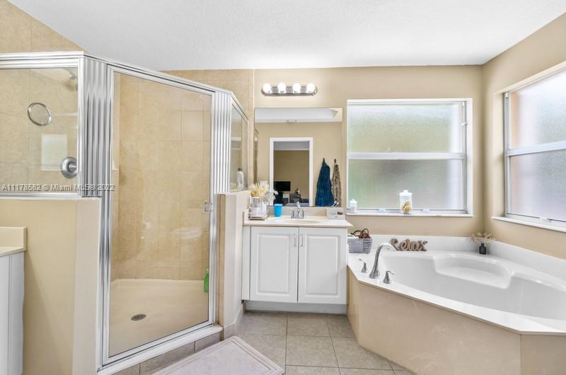 Unincorporated West Palm Beach West Palm Beach, FL 33411 - Photo 4 of 26 a large bathroom with a tub shower sink and mirror