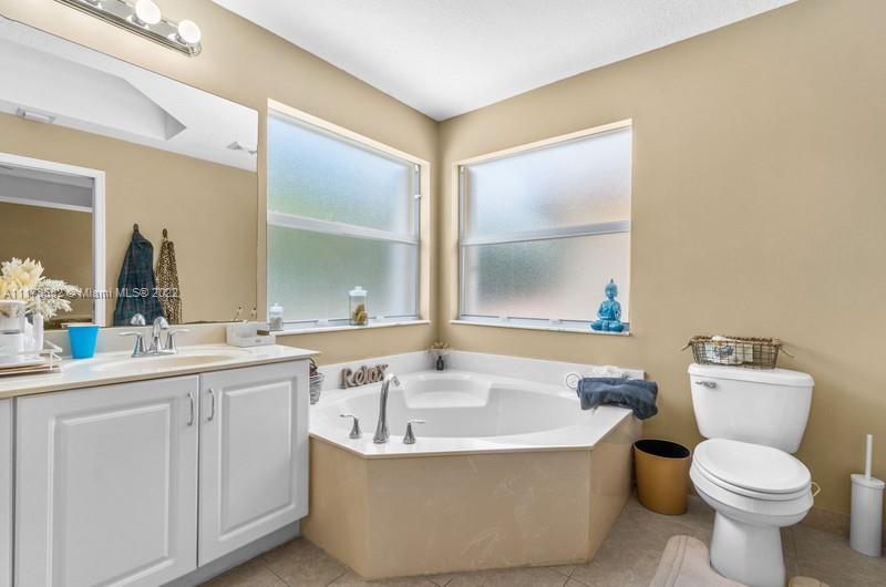 Unincorporated West Palm Beach West Palm Beach, FL 33411 - Photo 5 of 26 a bathroom with a sink and mirror with toilet