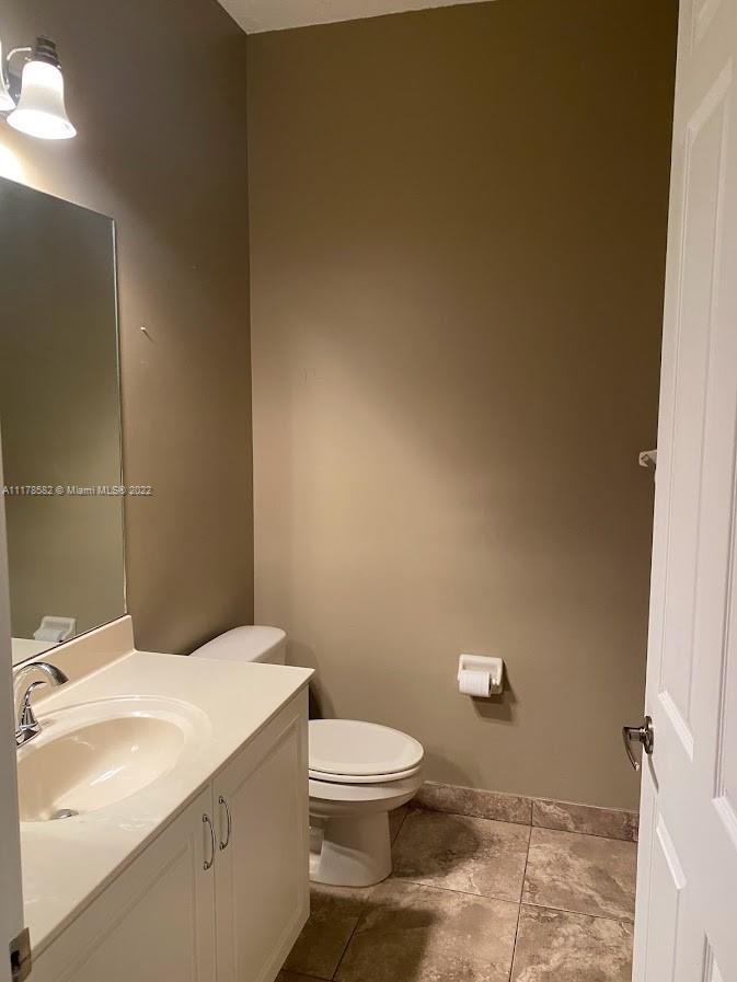 Unincorporated West Palm Beach West Palm Beach, FL 33411 - Photo 7 of 26 a bathroom with a granite countertop toilet and a sink