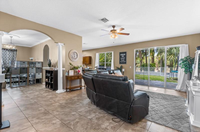 Unincorporated West Palm Beach West Palm Beach, FL 33411 - Photo 8 of 26 a living room with furniture large window and flat screen tv