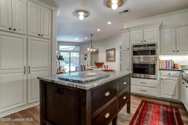 a bedroom with furniture and a flat screen tv