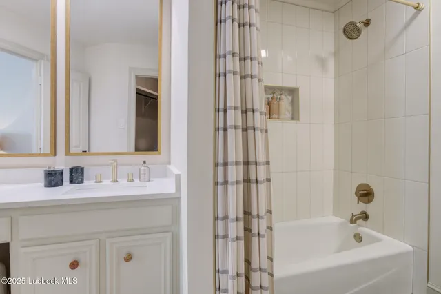 a view of a backyard with plants and wooden fence