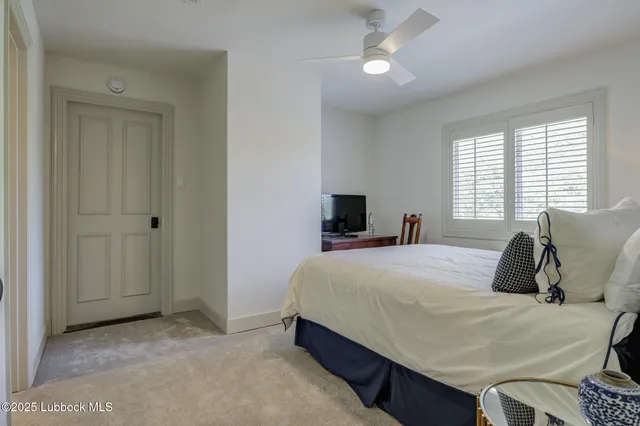 a view of a house with pool table and chairs under an umbrella