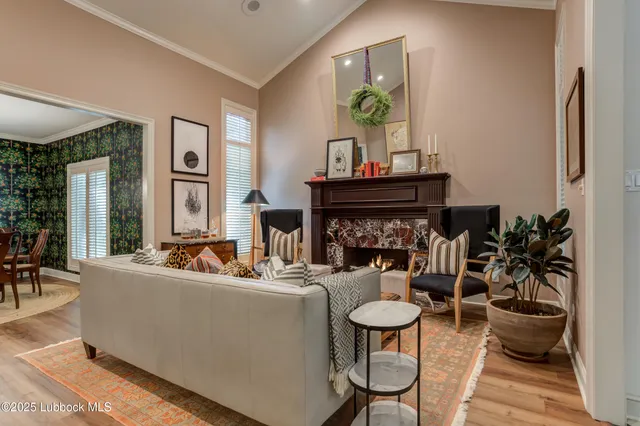 a living room with furniture a fireplace and a large window