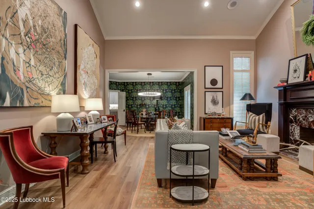a view of a dining room with furniture a chandelier and wooden floor