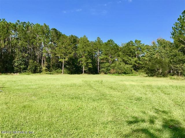 3098 Pacetti Road, Unit G St. Augustine, FL 32092 - Photo 1 of 17 a view of outdoor space with green field and trees
