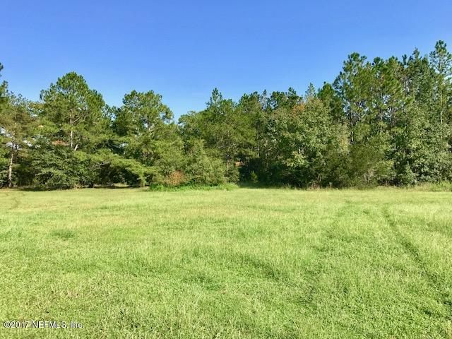 3098 Pacetti Road, Unit G St. Augustine, FL 32092 - Photo 2 of 17 a view of a yard with an tree