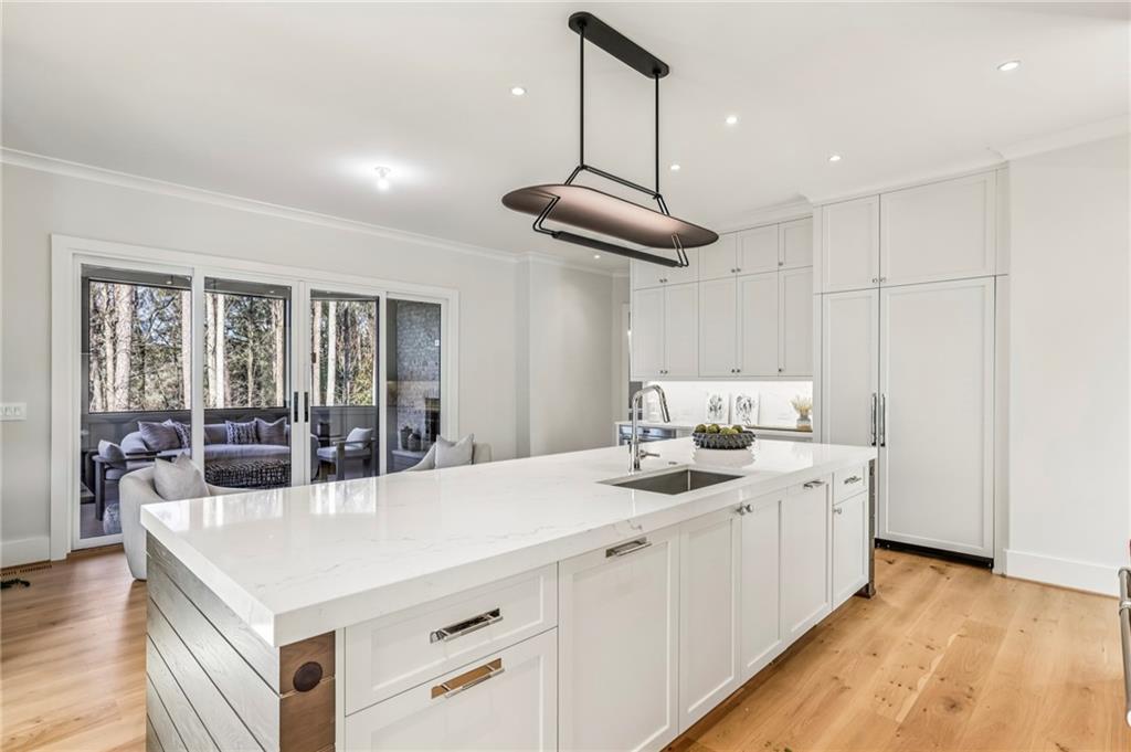 825 Kenry Court Atlanta, GA 30342 - Photo 16 of 49 a kitchen with stainless steel appliances a sink a stove a refrigerator and cabinets