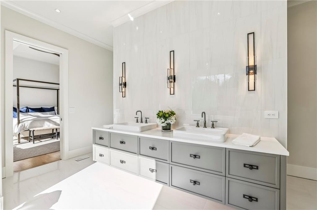 825 Kenry Court Atlanta, GA 30342 - Photo 24 of 49 a spacious bathroom with a double vanity sink and a mirror