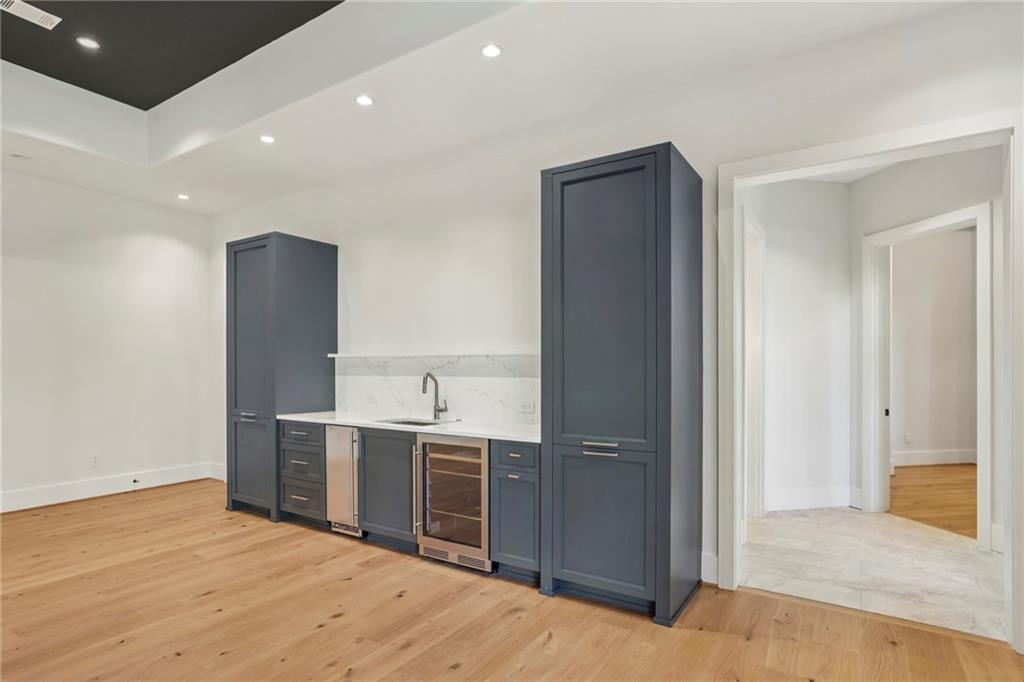 825 Kenry Court Atlanta, GA 30342 - Photo 41 of 49 a view of a kitchen with kitchen island stainless steel appliances wooden floor and view living room
