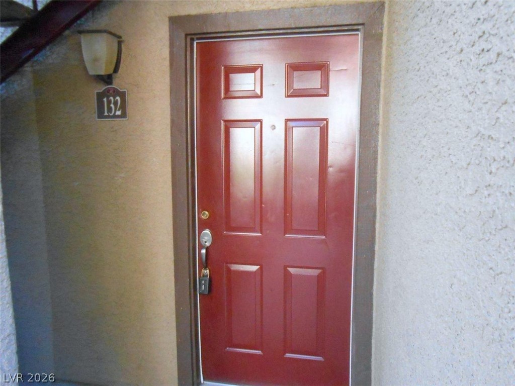 A vibrant red entry door offers a welcoming invitation to this property.