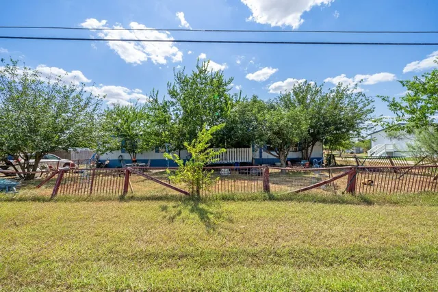 a view of a swimming pool with a bench and trees