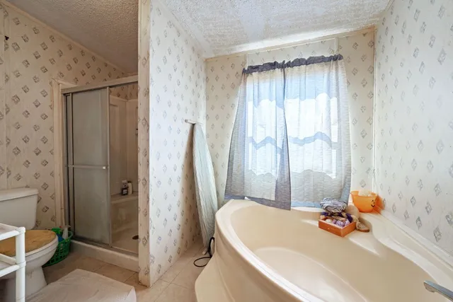a bathroom with a tub and shower