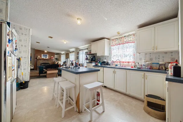 a kitchen with cabinets and chairs